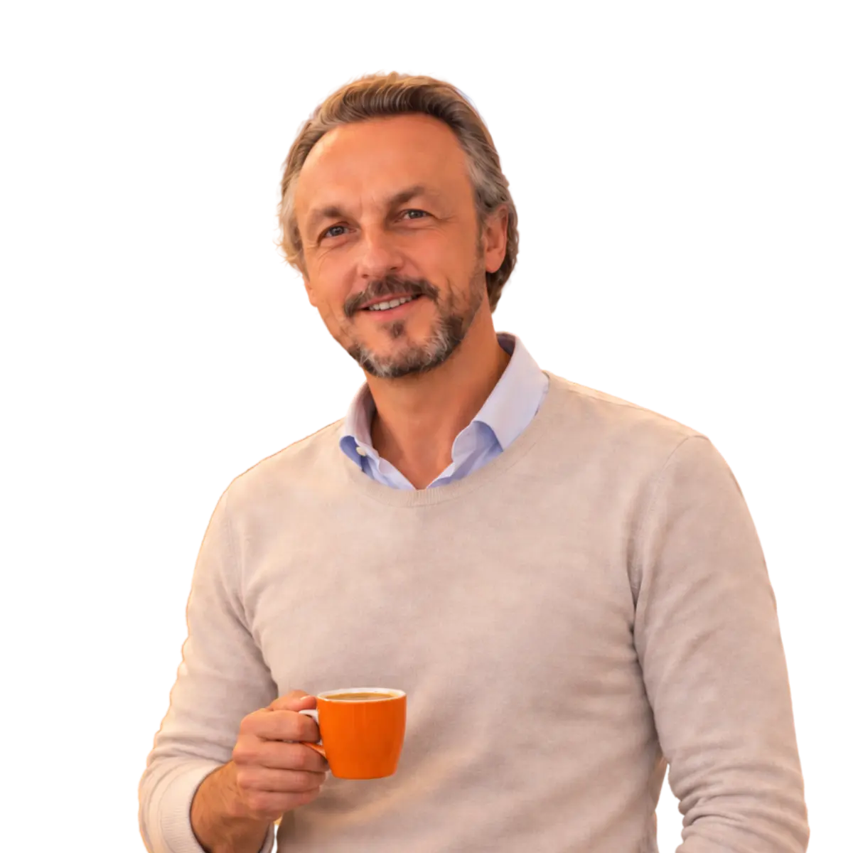Nicolas Van Caemerbeke, coach professionnel, souriant, une tasse orange de café à la main